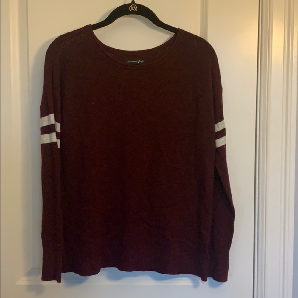 maroon american eagle sweater with white on sleev